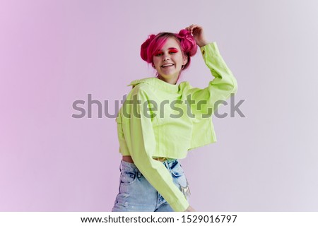young woman with beautiful hair in stylish clothes looking at the camera