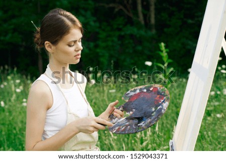 young beautiful woman with paints for painting