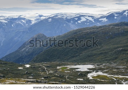 Landscape photo of the trail path to the cliff Trolltunga in the Norwegian mountains.