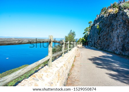 Landscape accompanied by a railing, on top of a stone wall. made of wood Royalty-Free Stock Photo #1529050874