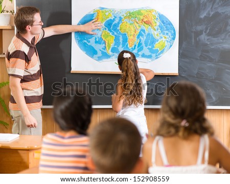 Young teacher with his class at geography lesson Royalty-Free Stock Photo #152908559