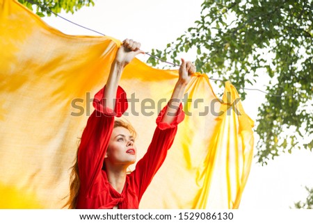 stylish young happy woman in summer dress in the forest