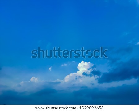 Clear sunny blue sky in winter season with clouds and space for text