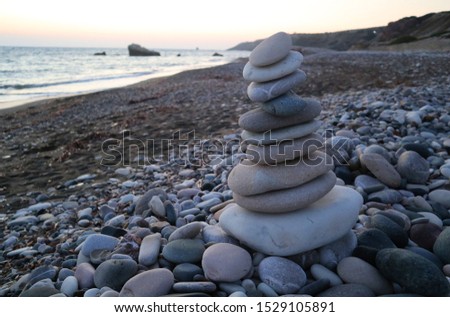 Pyramid of rounded pebble stones                             