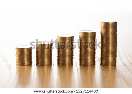 Coins stacked on wooden table