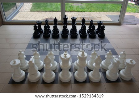 White chess pieces against black side view with text box