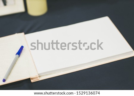 Wedding album, blank page, guest list, to do list.still life photography concept by memory and notebook.Notepad book.Notebook and asters on canvas background.soft and blur style for background.