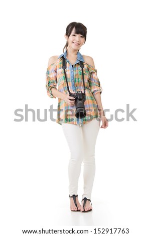 Beautiful smiling asian woman with photo camera. Full length portrait. Isolated on the white background.