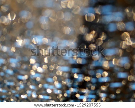 Abstract background. Bokeh made of shiny city sidewalk.
