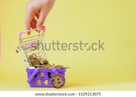 Cryptocurrency digital payment concept, various of silver and golden physical digital crypto money coins in shopping basket.