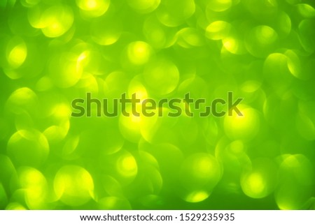 abstract yellow circle light on green background. Green blurred backdrop wallpaper.