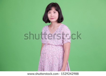 Portrait of beautiful Asian pregnant woman with short hair