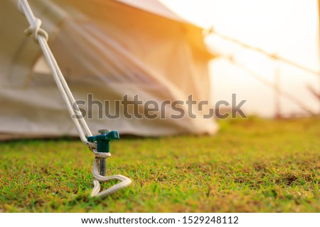 Close up of tent peg anchor on the ground   tent,hook of tent,camping Royalty-Free Stock Photo #1529248112