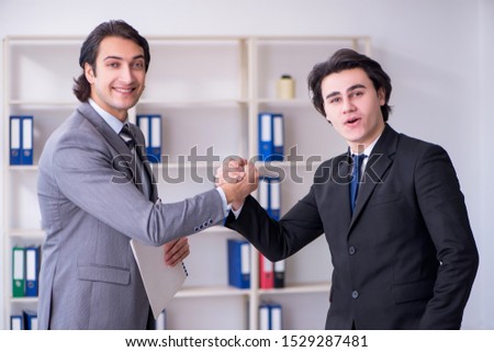 Two young businessmen meeting in the office