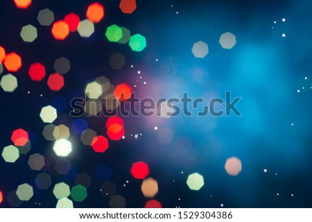 Bokeh of colorful lighting in 7 polygon heptagon in smoky night background with copyspace.
Defocused of beautiful  polygon lights and light ray.