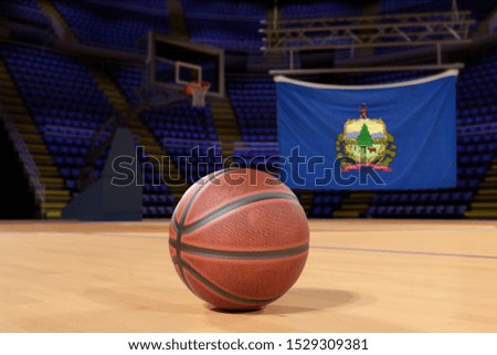 Vermont state flag and basketball on Court Floor