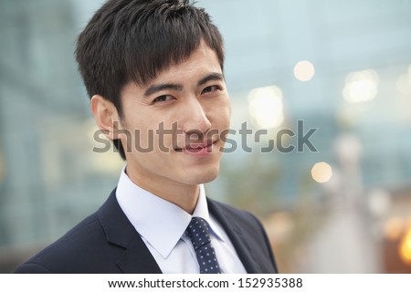 Close-up portrait of confident young businessman, China