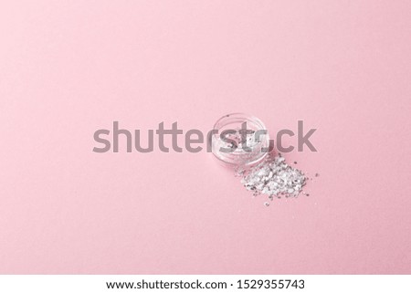 box with gray glitter on a pink background, copy space