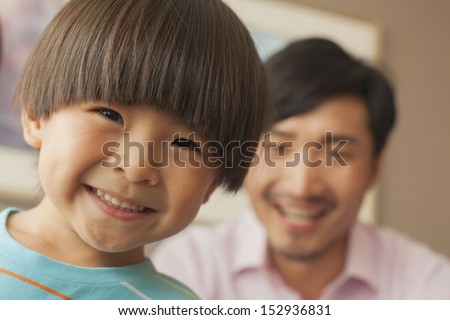 son with father smiling, portrait
