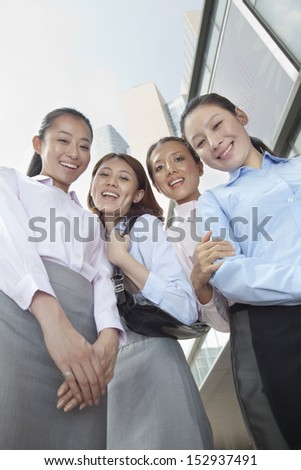 Four young businesswomen looking at the camera