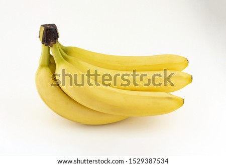 Banana stack isolated on white background. Fresh yellow banana cluster. Ripe bananas. Royalty-Free Stock Photo #1529387534