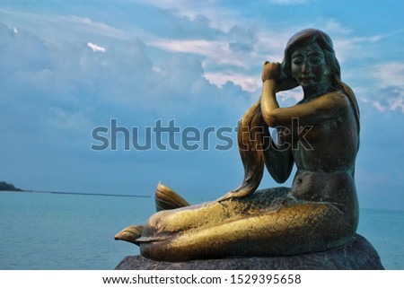 The little Mermaid statue in Hatyai beach Thailand with bluesky and copy space background.