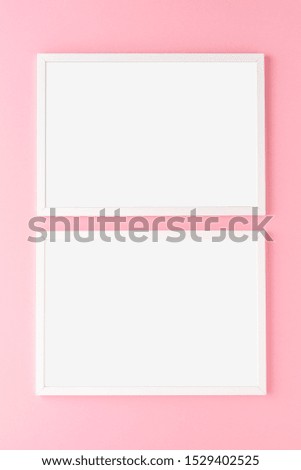 Two empty picture frames on pink wall. Mockup with copyspace