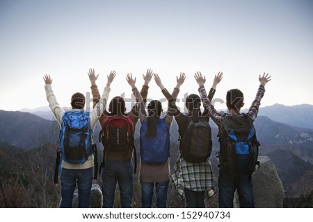 Group of people standing with hands outstretched