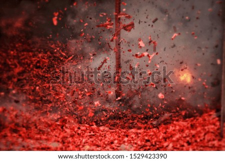 Ten thousand of firecracker for auspicious times exploding and make fire spark point and a lot of smoke background.Close up