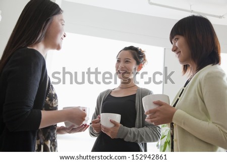 Three businesswomen on the coffee break in the office
