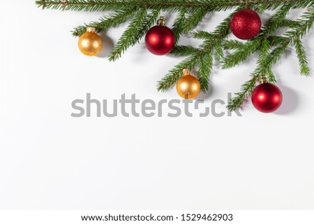 Christmas border of fir branches, gold and red balls on a white background. Flat lay, top view, copy space. Christmas background.