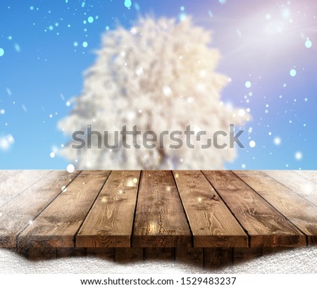 Merry christmas and happy new year greeting background with table .Winter landscape with snow and christmas trees