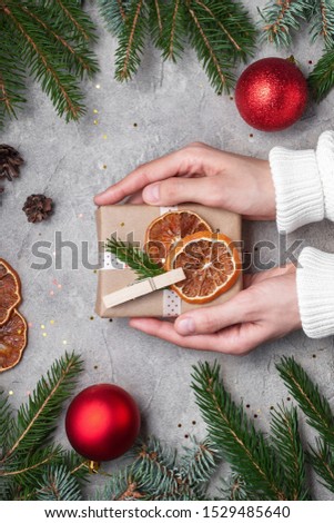 Christmas composition. Gifts, fir tree branches, red decorations on black background. New year concept. Flat lay, top view.