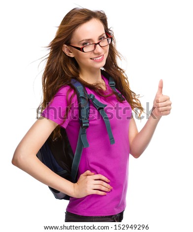 Young student girl is showing thumb up sign, isolated over white