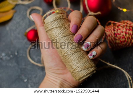 Women's hands with colorful pattern on the nails. Top view. Place for text. cozy winter style.