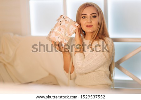 Elegant woman in white dress in winter holiday. Christmas mood