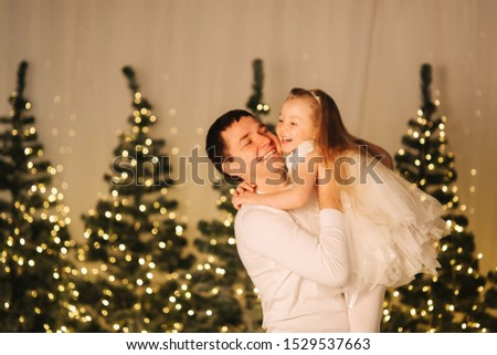 Dad play with his cute little daughter on holiday. Chrisrmas mood