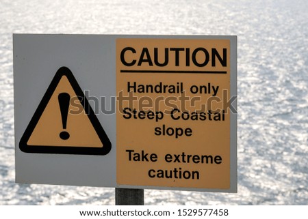 Yellow and white Caution , Handrail only Steep Coastal slope, Take extreme caution