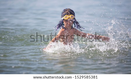 Girl 7 years old plays in the sea
