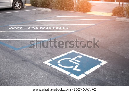 Free space Handicapped parking spot in motel or apartment, transportation infrastructure road markings.
