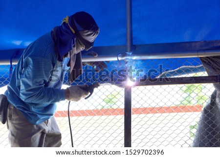 male craftsman is welding the iron                 