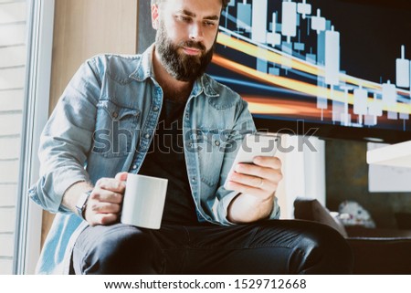 Office manager having break, relaxing at workplace. Man using smartphone for online communication in social media. Guy texting in networks, reading updates, sharing. Male person dialing phone number