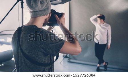 Fashion photo shoot. Professional occupation hobby. Male model posing in studio. Session backstage.