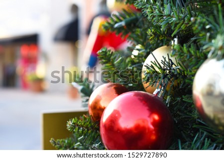 Close up on colorful Christmas tree ornaments with blury background. Red and gold glass balls.