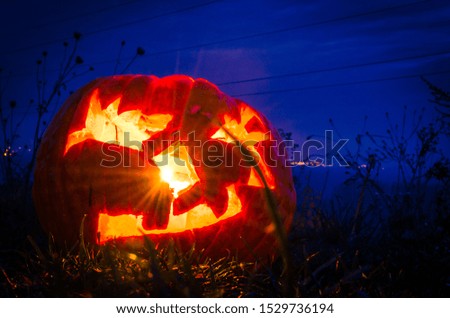 spooky carved traditional halloween pumpkins illuminated against black background