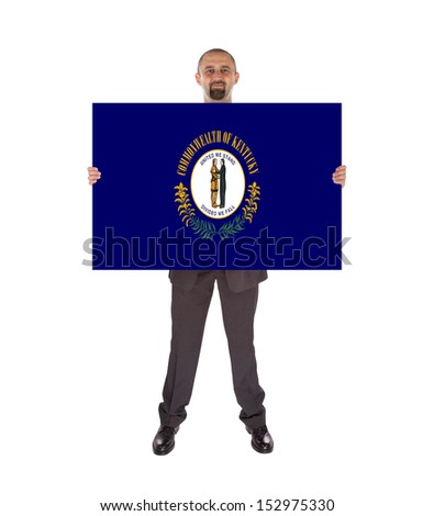 Smiling businessman holding a big card, flag of Kentucky, isolated on white