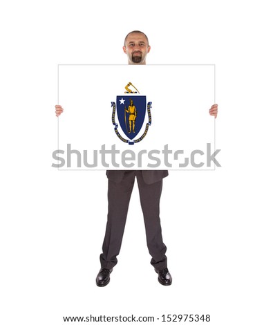 Smiling businessman holding a big card, flag of Massachusetts, isolated on white