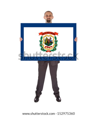 Smiling businessman holding a big card, flag of West Virginia, isolated on white