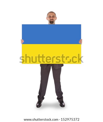 Smiling businessman holding a big card, flag of Ukraine, isolated on white