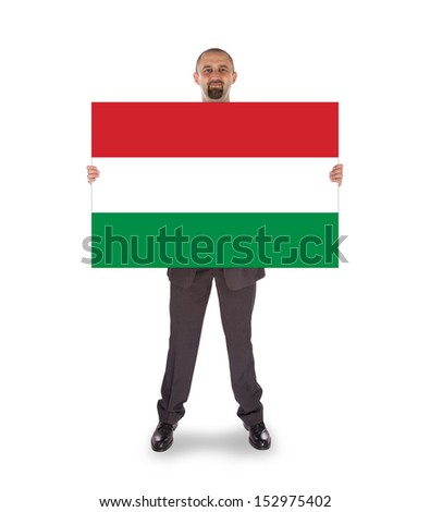 Smiling businessman holding a big card, flag of Hungary, isolated on white